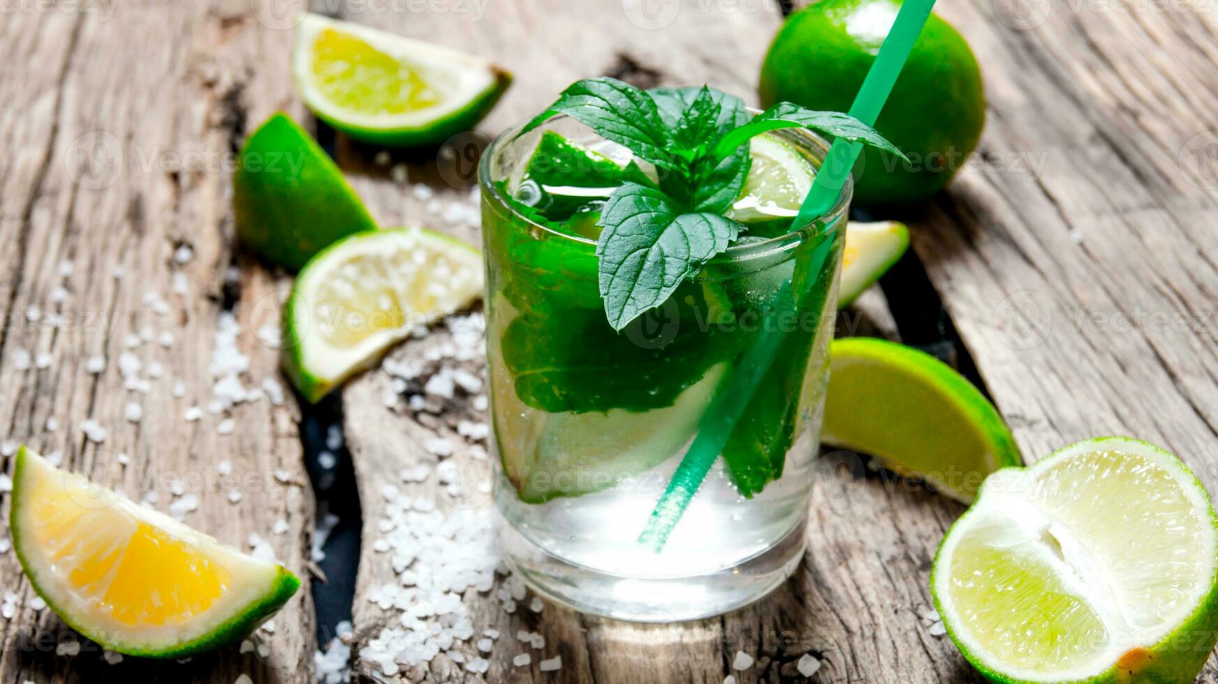 Freshly made mojito with mint and lime, sugar and rum. On a wooden table. photo