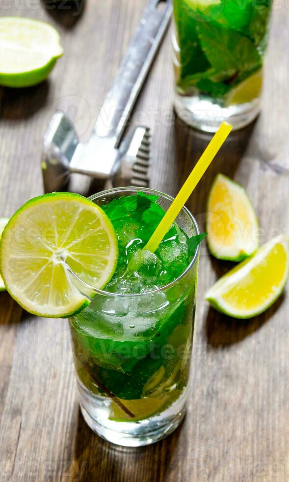 Freshly made mojito with mint and lime, sugar and rum. On a wooden table. photo