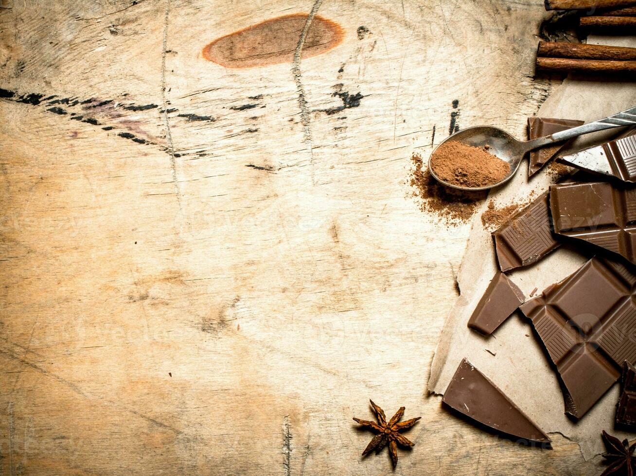 Pieces of milk chocolate with cocoa and cinnamon. photo