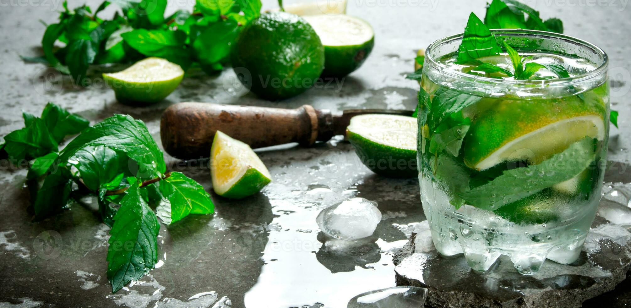 Fresh Mojito with lime and mint on the stone table. photo