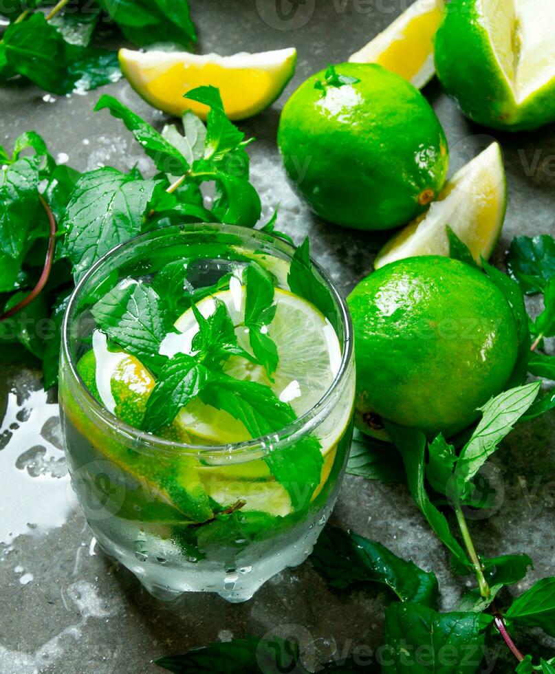 Fresh Mojito with lime and mint on the stone table. photo