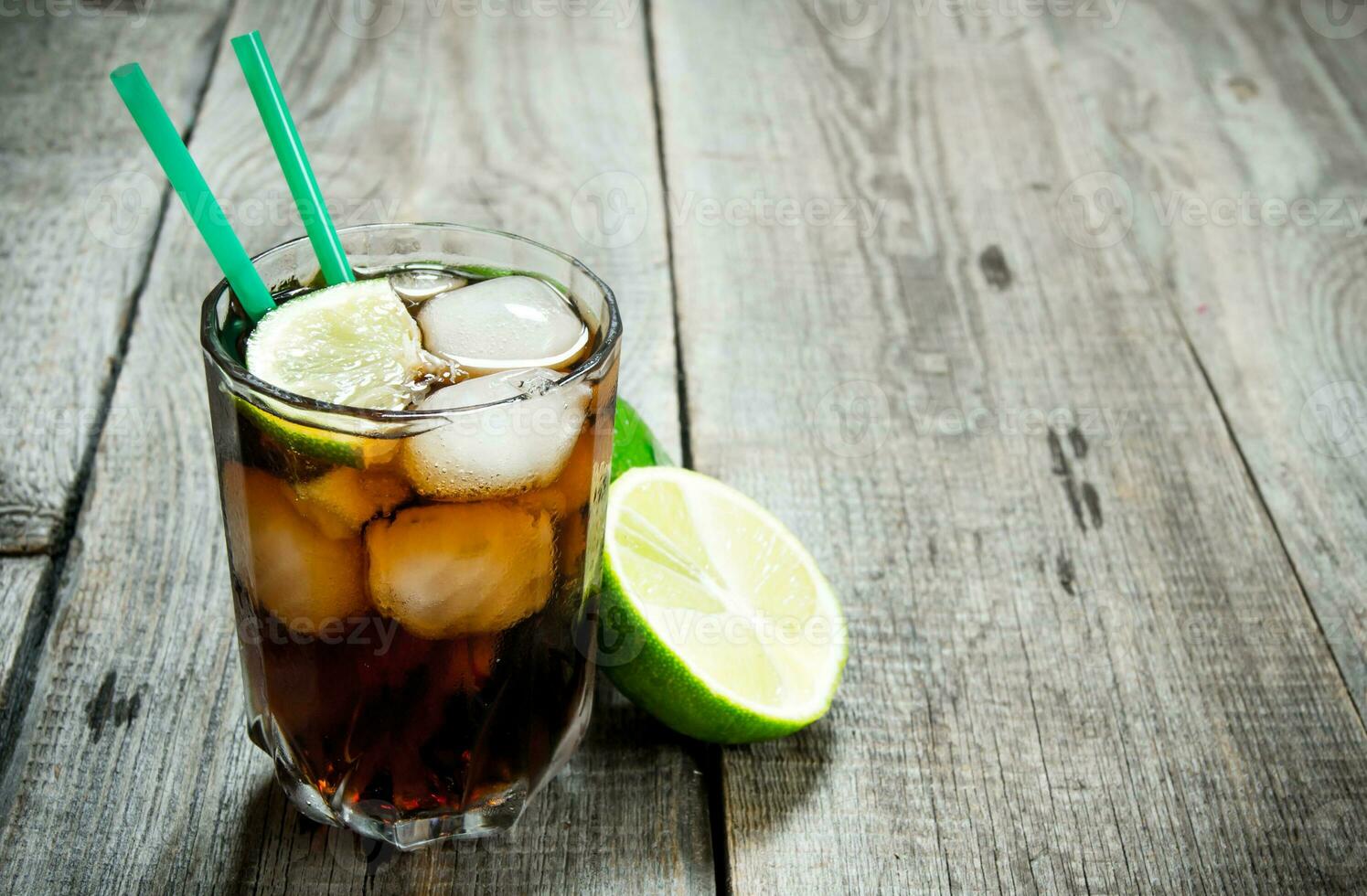 Fresh cocktail with lime and mint on wooden table. Free space for text. photo