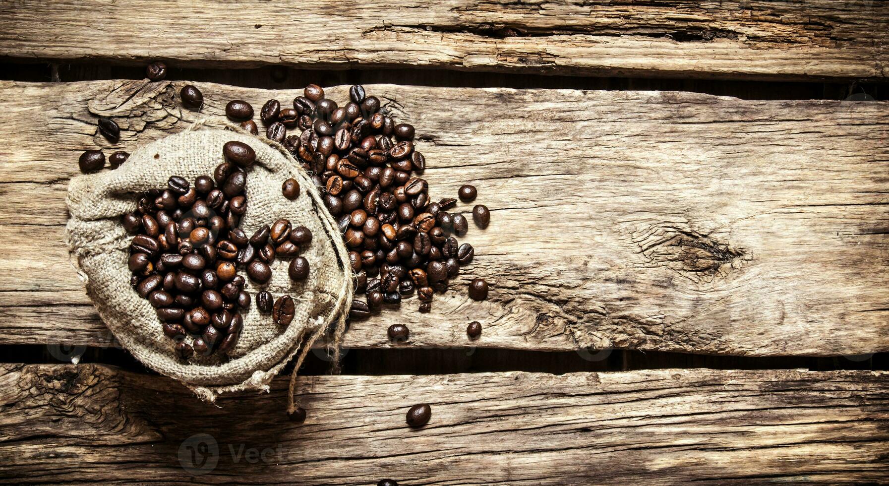 Roasted coffee beans in an old bag. photo