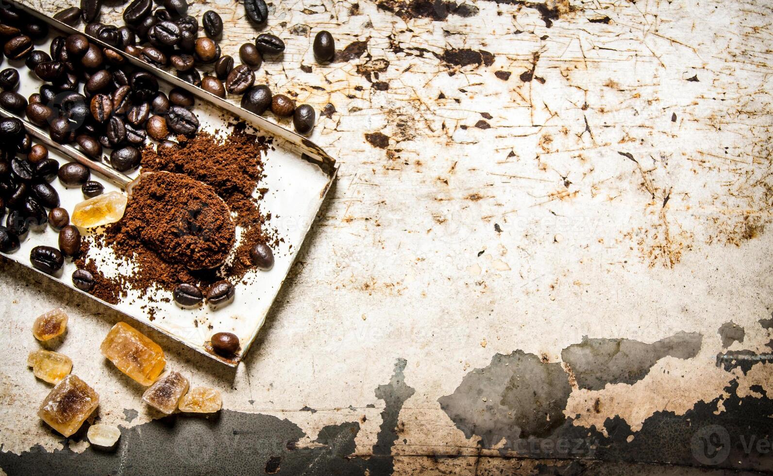 Roasted coffee with a spoon of ground. photo