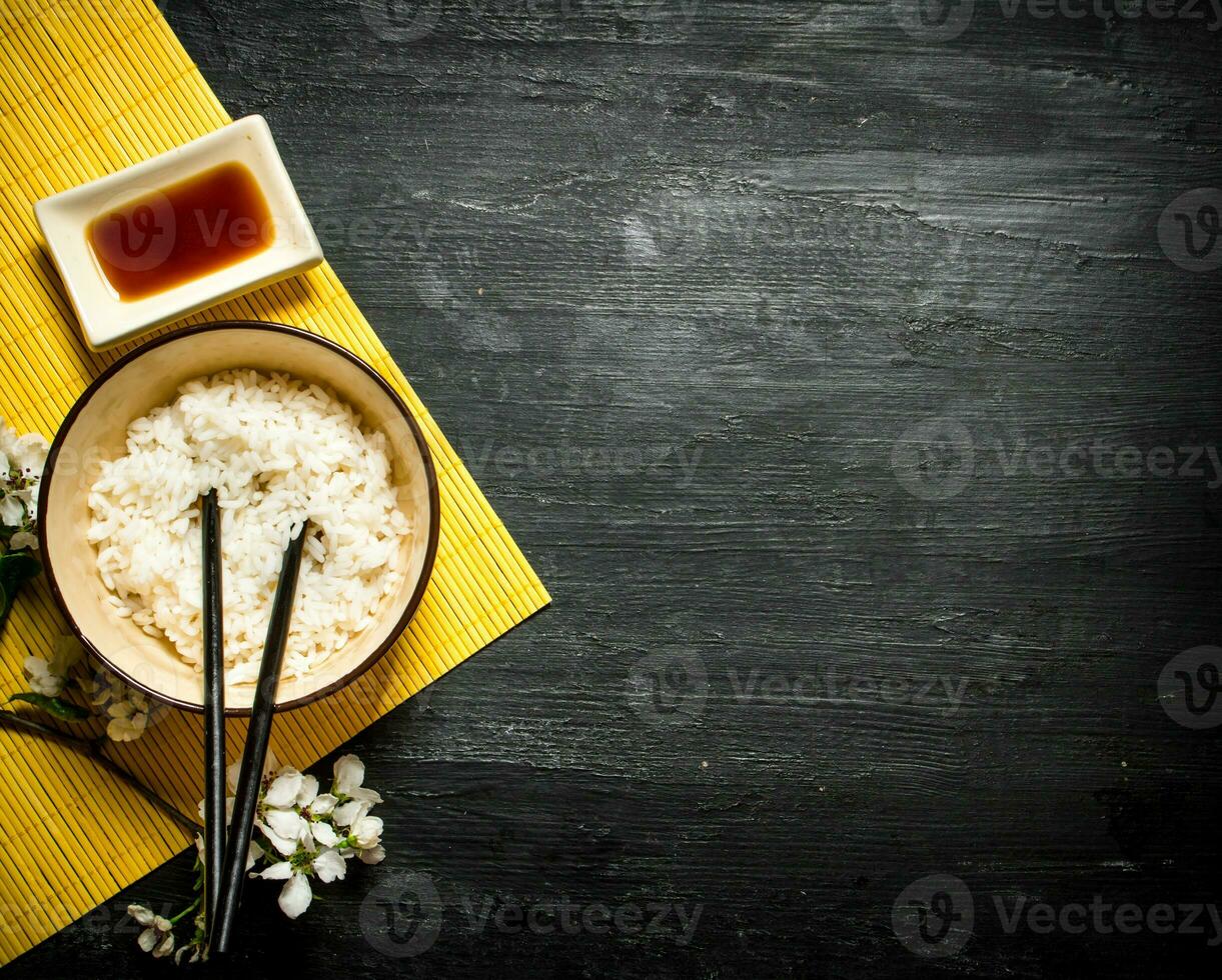 Boiled rice with soy sauce and the cherry branches photo