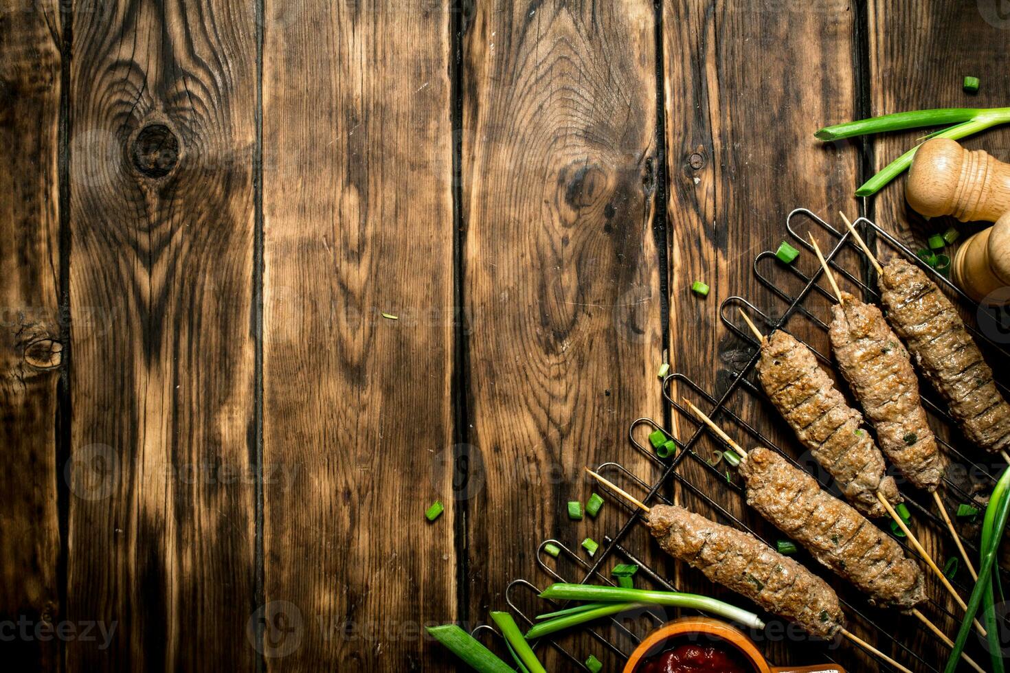 Kebab with tomato sauce and green onions. photo