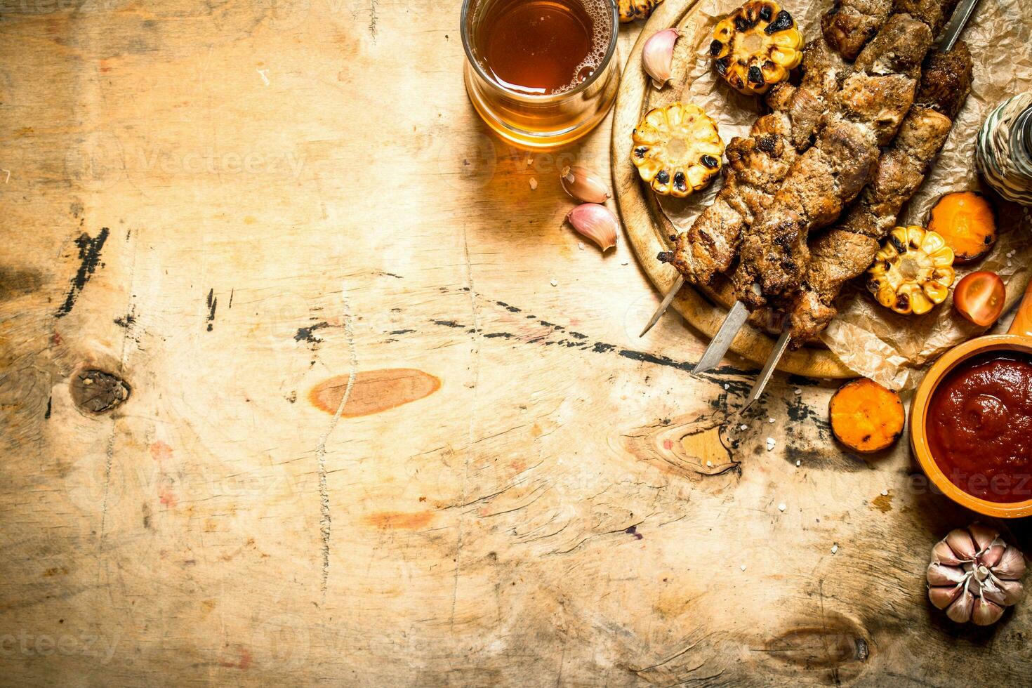 Shish kebab with roasted vegetables and beer. photo