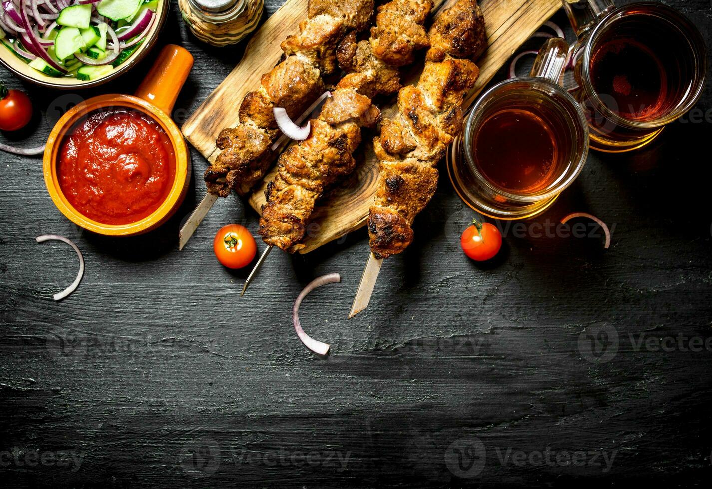 Hot Shish kebab with a cold beer. photo