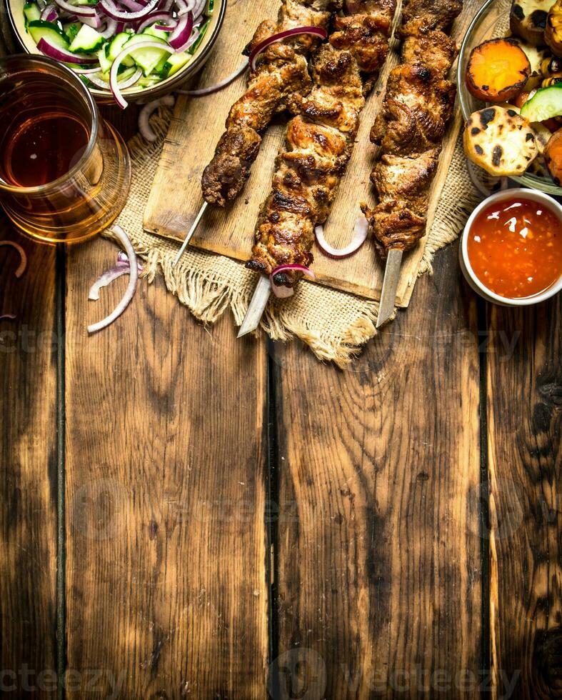 Grilled vegetables with a fragrant Shish kebab from mutton. photo