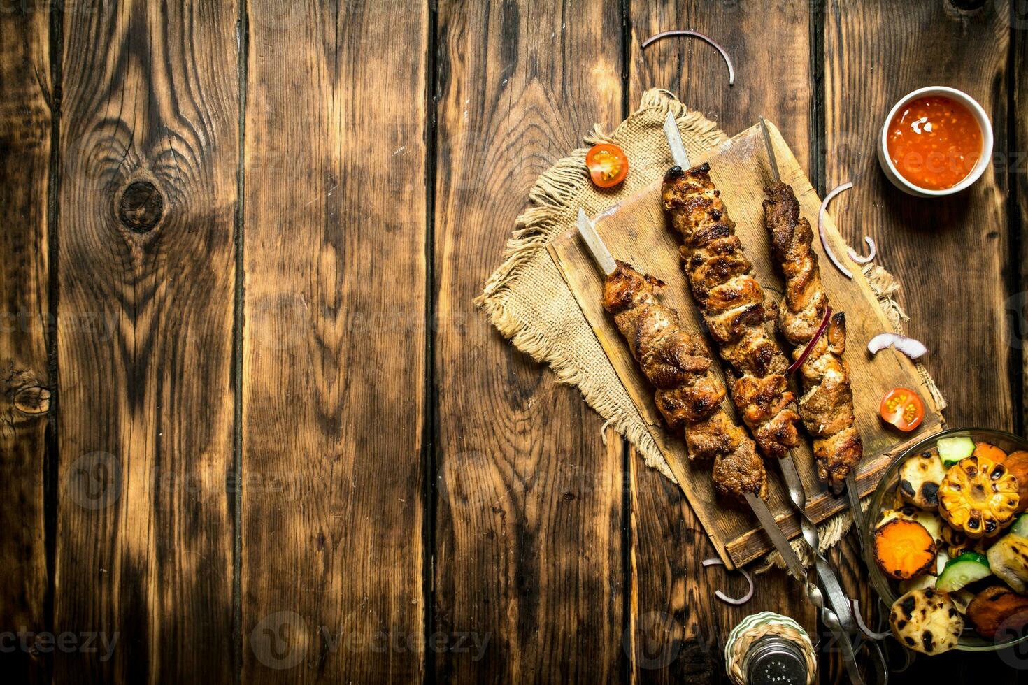 Grilled vegetables with a fragrant Shish kebab from mutton. photo