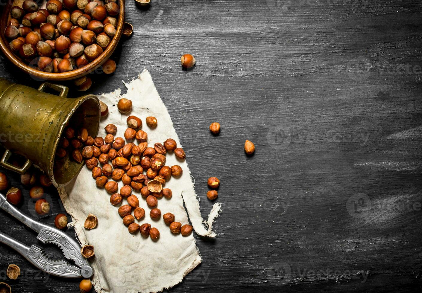 Shelled hazelnuts with Nutcracker and mortar of the old fabric. photo