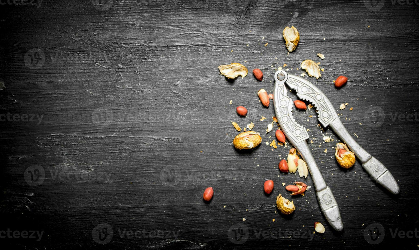 Shelled peanuts with the shell and a Nutcracker. photo