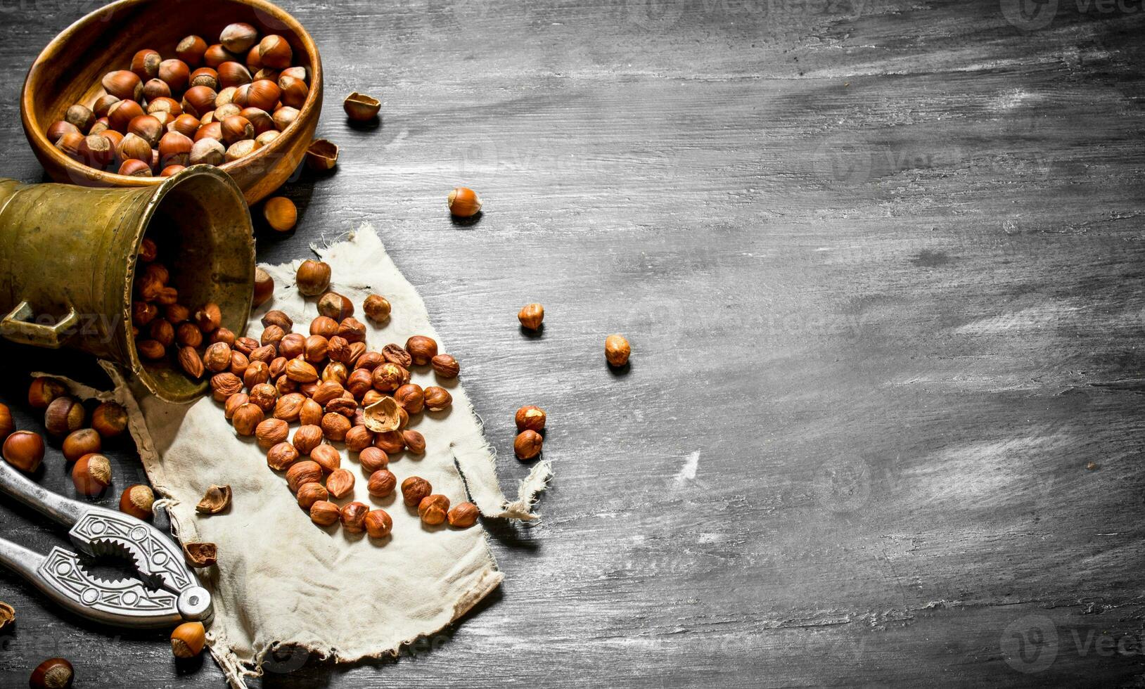 Shelled hazelnuts with Nutcracker and mortar of the old fabric. photo