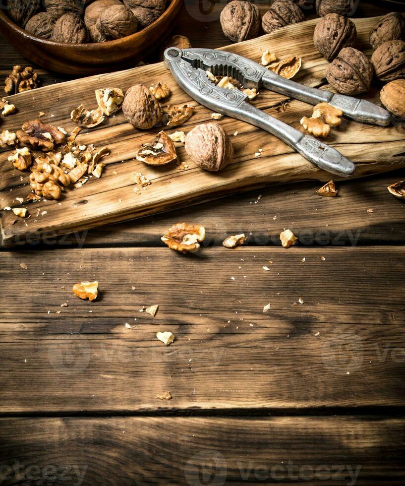 Walnuts with Nutcracker on the Board. photo