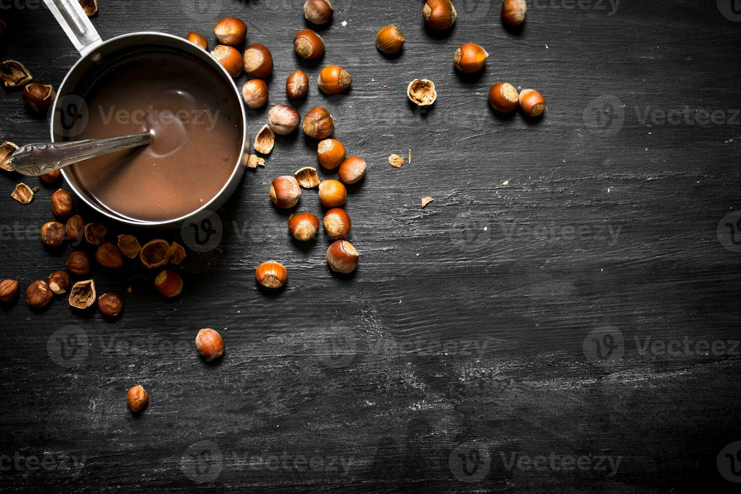 Chocolate butter with hazelnuts in a pan. photo