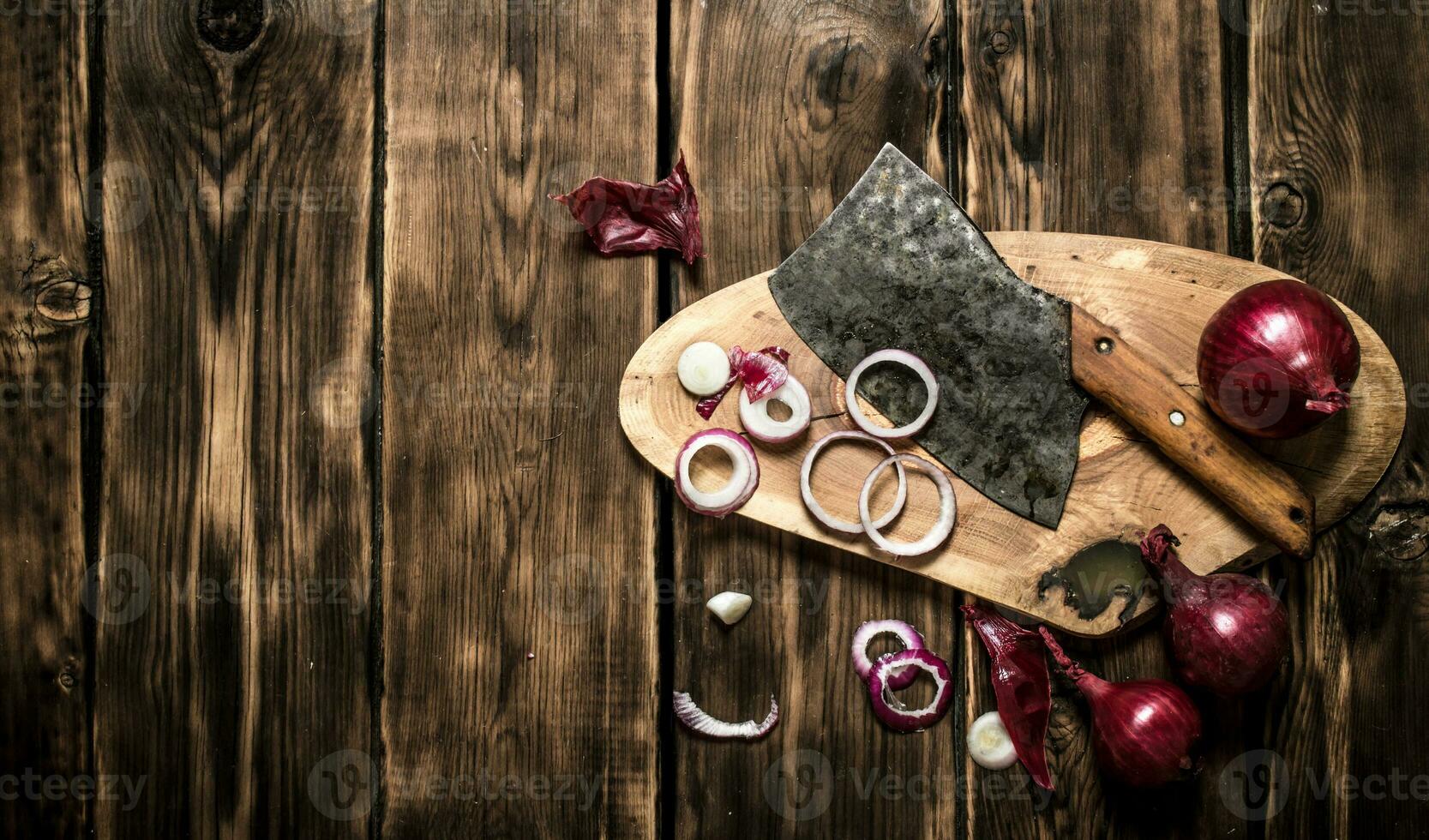 Sliced red onion and an old hatchet. photo