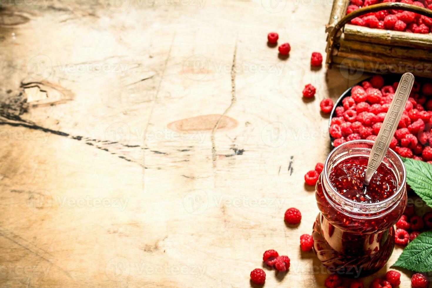 Sweet raspberry jam in jar with spoon. photo