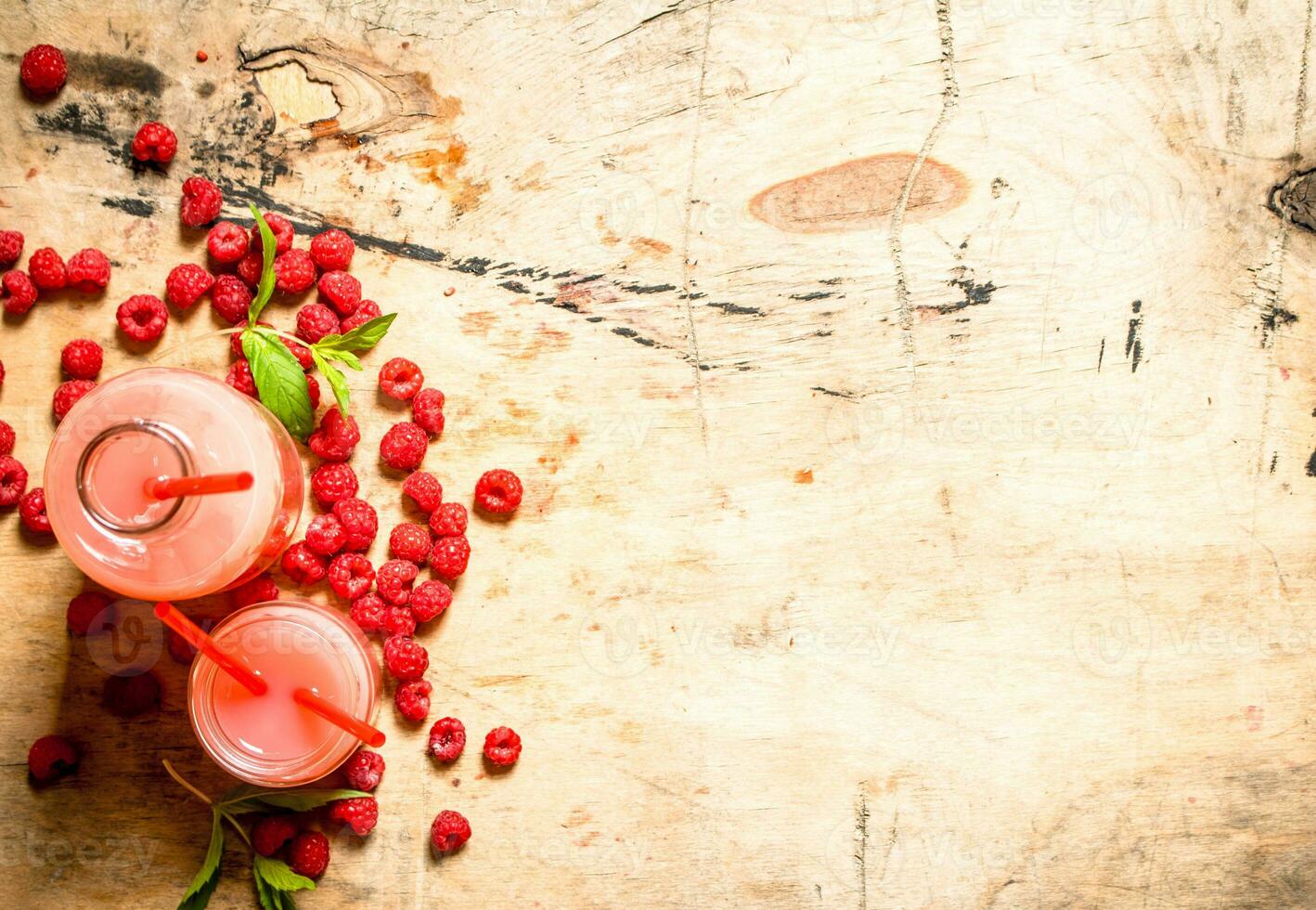 Raspberry juice in the pitcher and glasses. photo