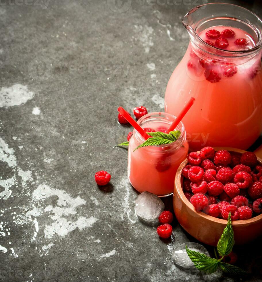 Raspberry juice with the berries and ice. photo