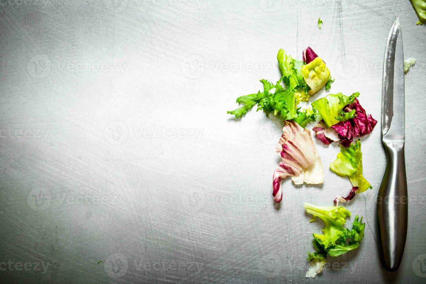 Fresh greens with a knife. photo