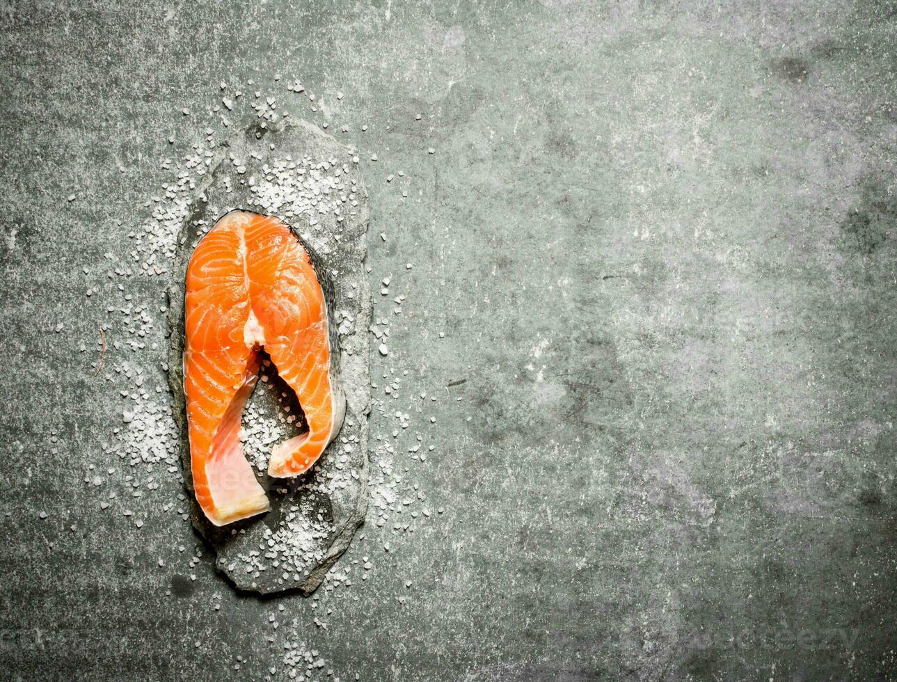 piece of raw trout with salt. photo