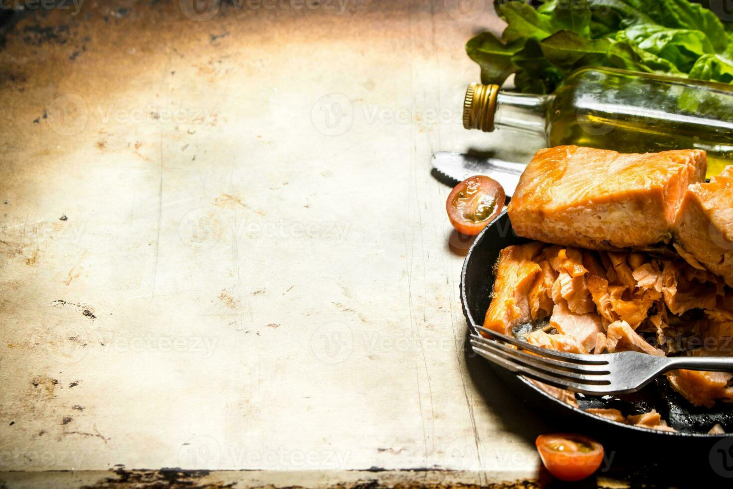 Fried trout at the plate with a fork. photo