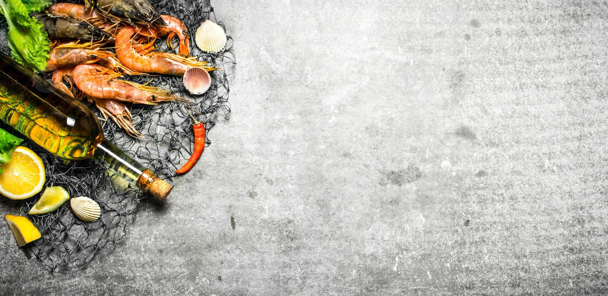 Fresh shrimp with a bottle of white wine photo