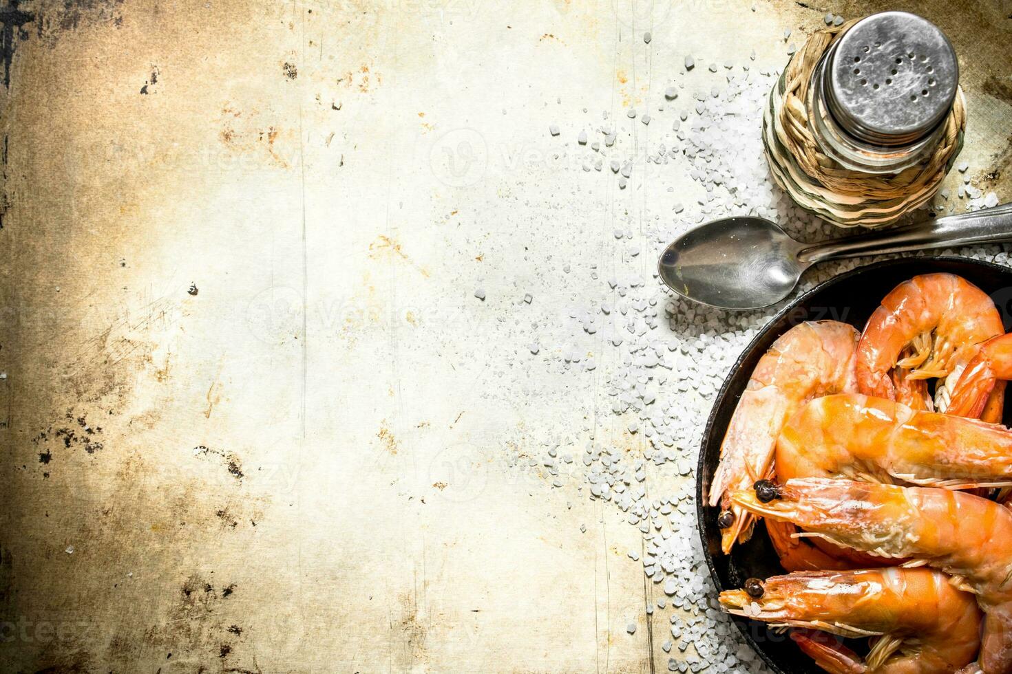 Frying pan with shrimp and salt. photo