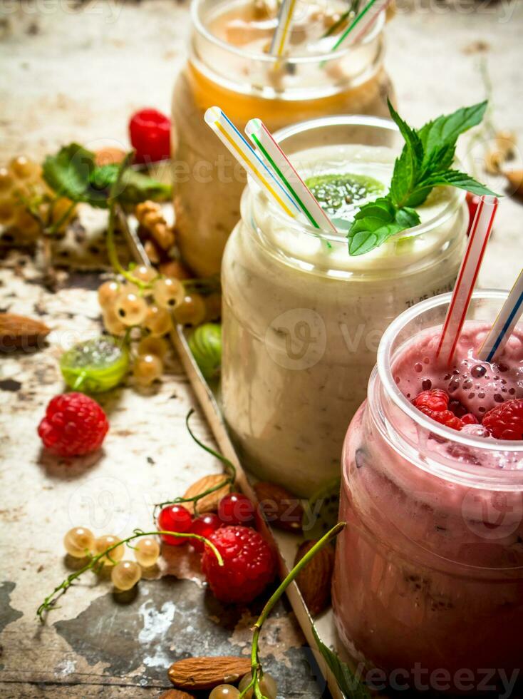 Berry smoothie made from currants, gooseberries and raspberries with nuts. photo
