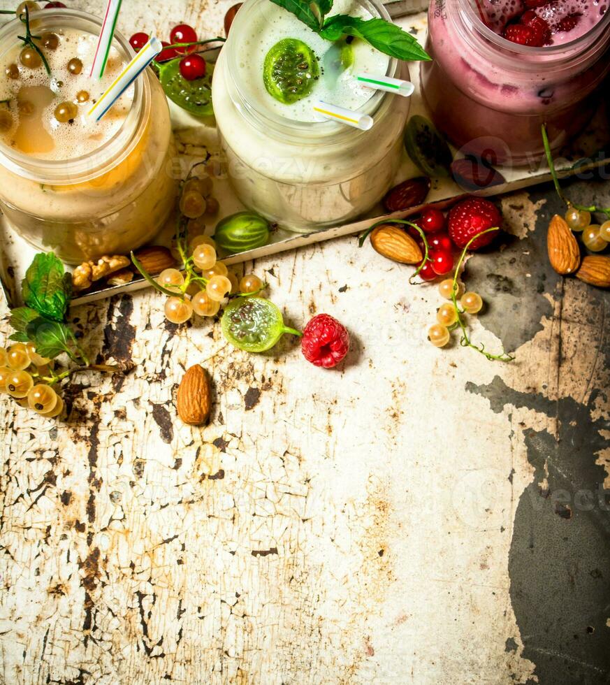 Berry smoothie made from currants, gooseberries and raspberries with nuts. photo