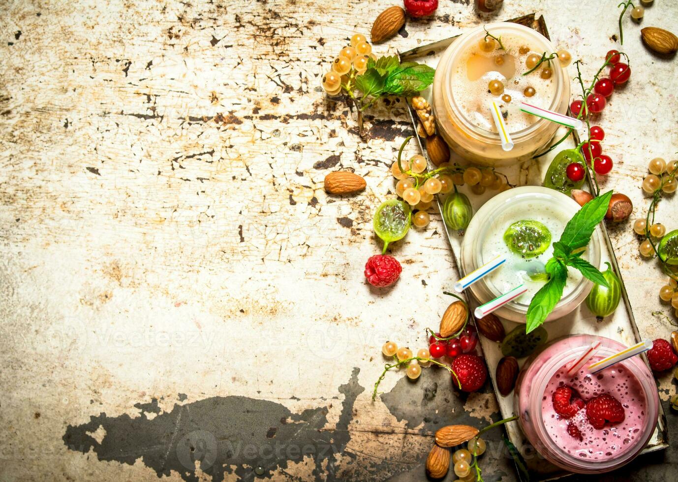 Berry smoothie made from currants, gooseberries and raspberries with nuts. photo