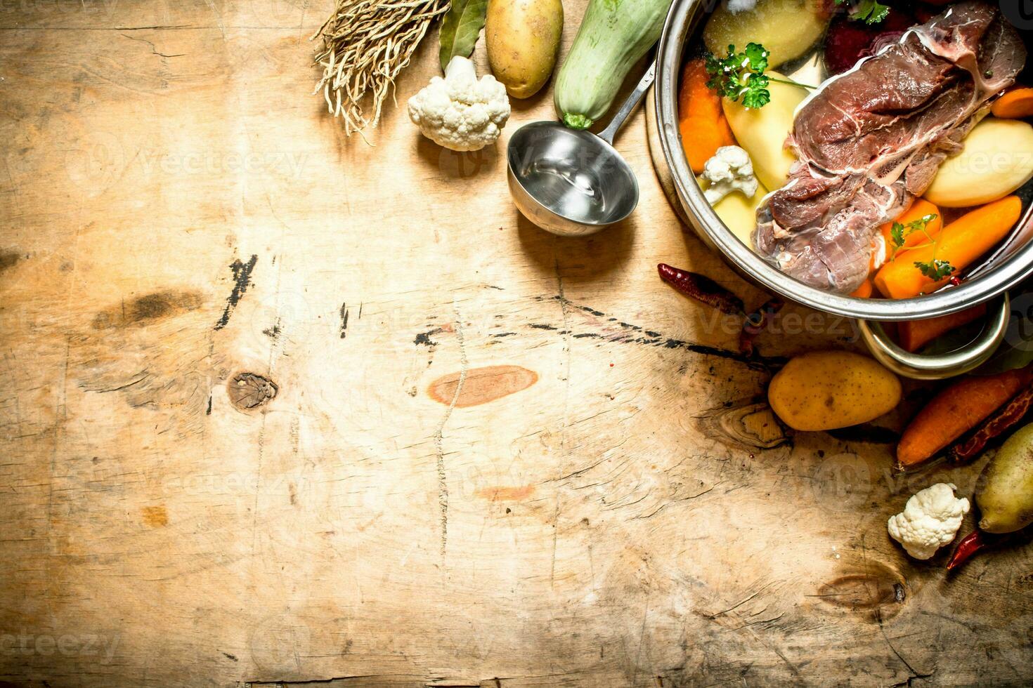 big pot of soup with beef and fresh vegetables. photo
