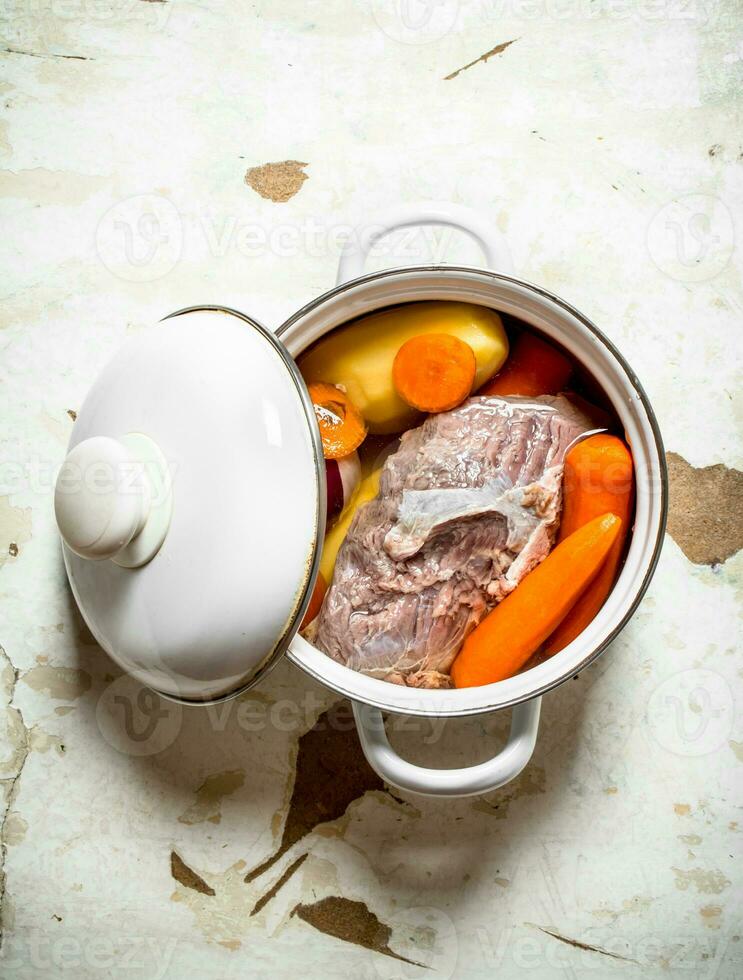 The pot of soup from meat and vegetables. photo