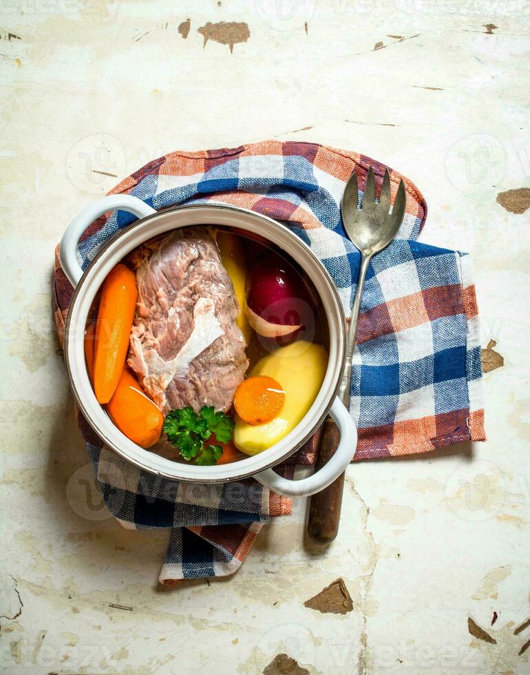 big pot of soup with meat and fresh vegetables. photo