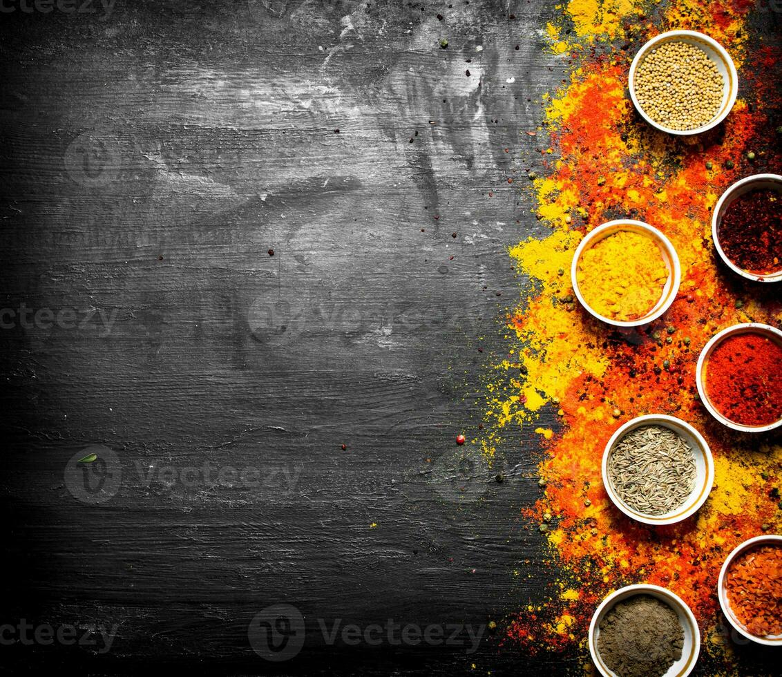 Big set of colored ground spices and herbs. photo