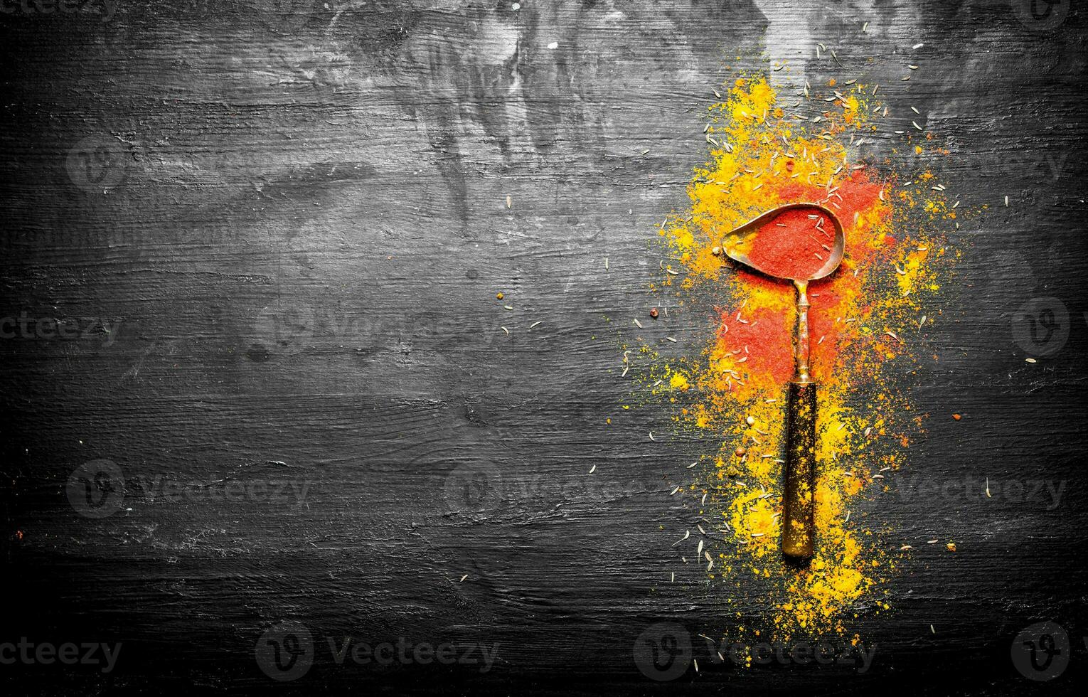 Grinded Indian spices in an old spoon photo