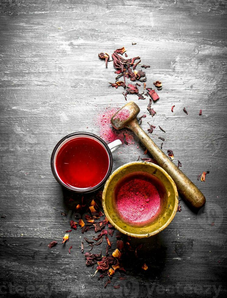 tea with pomegranate crushed in a mortar. photo