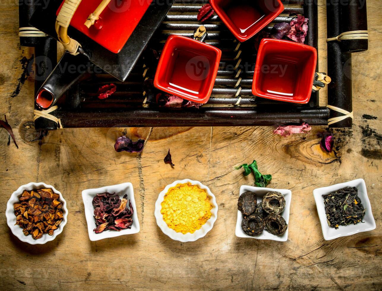 Different types of dried tea in the cups . photo