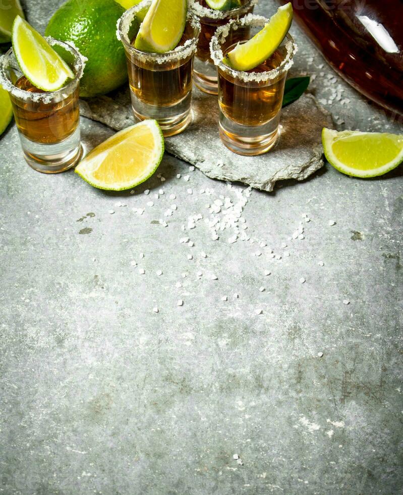 Tequila with salt and lime slices. photo