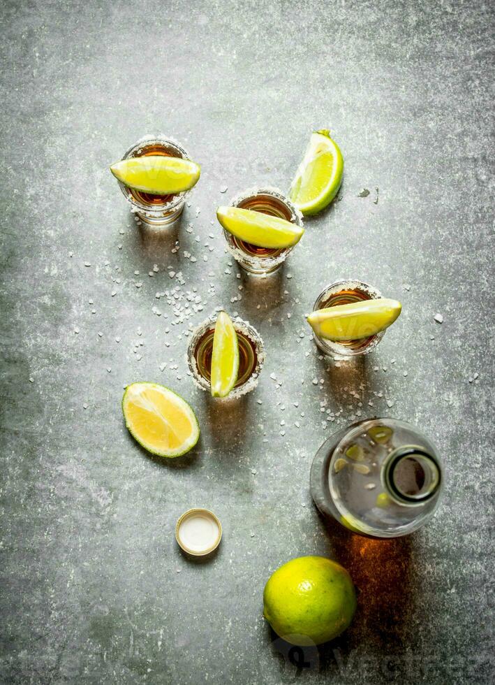 bottle of tequila with lime and salt. photo