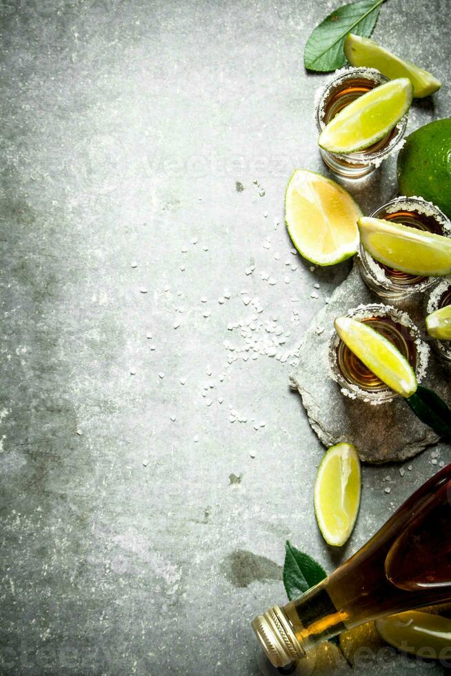 Tequila with salt and lime slices. photo