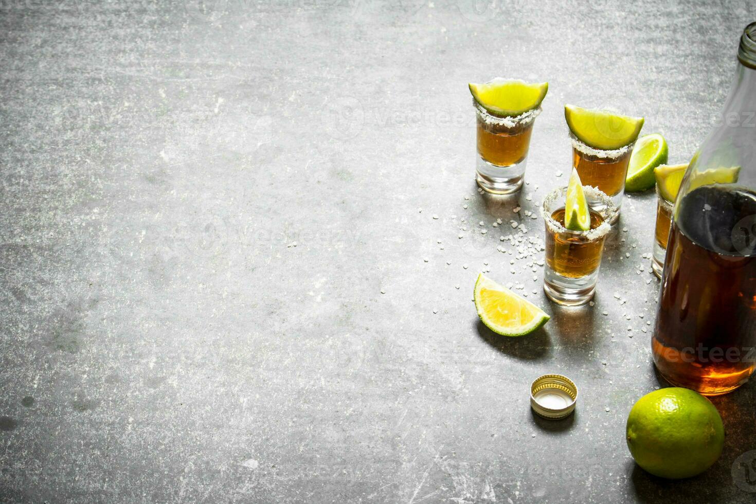 bottle of tequila with lime and salt. photo