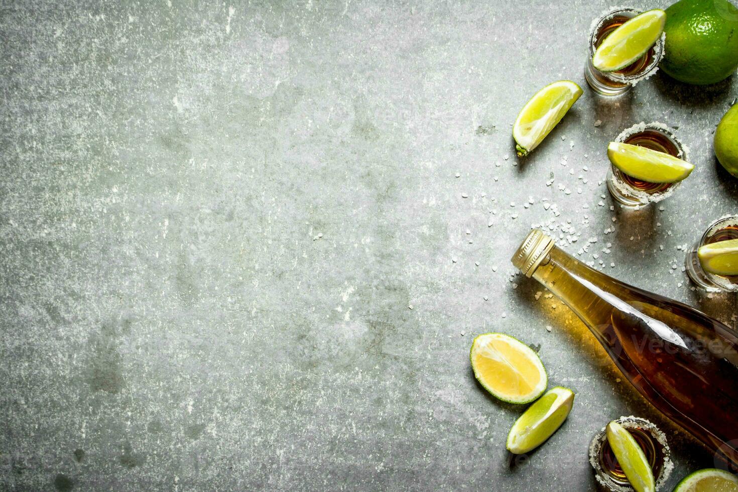 bottle of tequila with lime and salt. photo