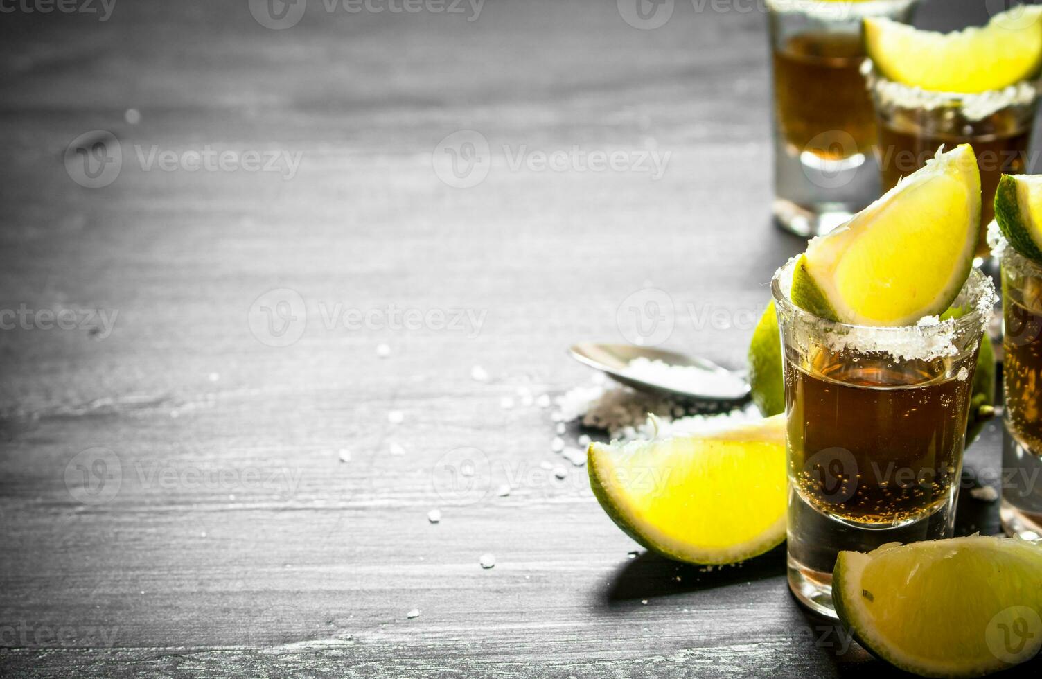 Tequila with salt and lime slices. photo