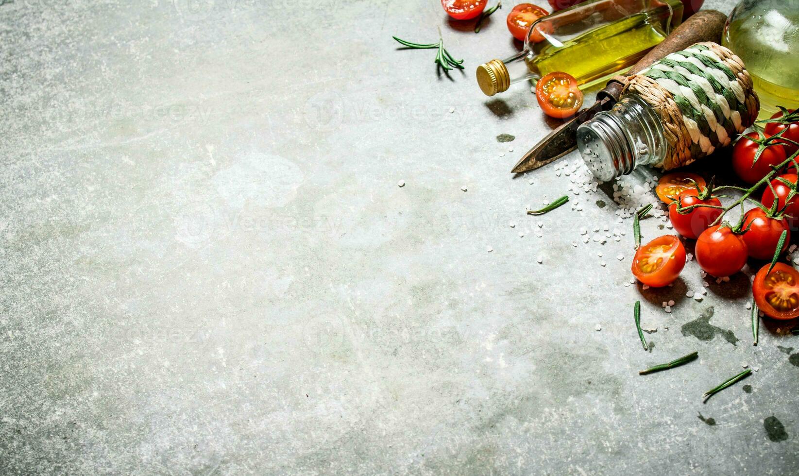 Tomatoes in the background. Fresh tomatoes, olive oil and spices. photo