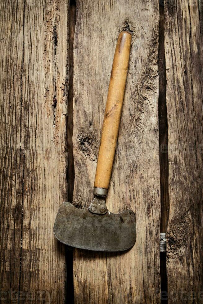Old carving knife . On wooden background. photo
