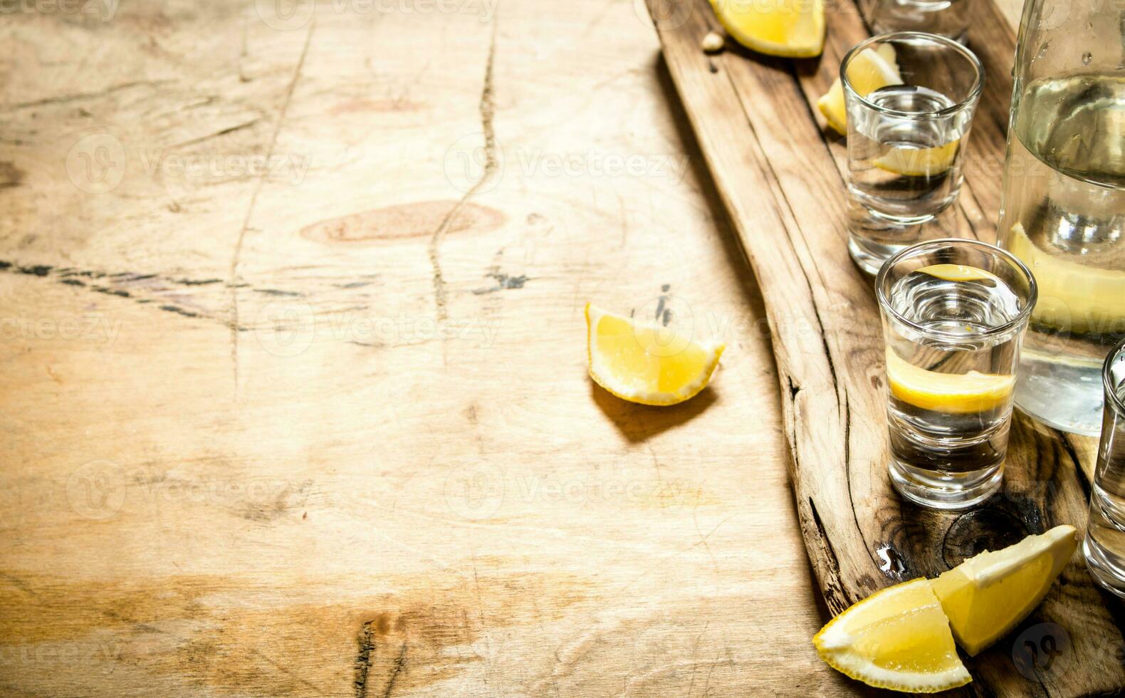 Vodka in shot glasses with lemon. photo
