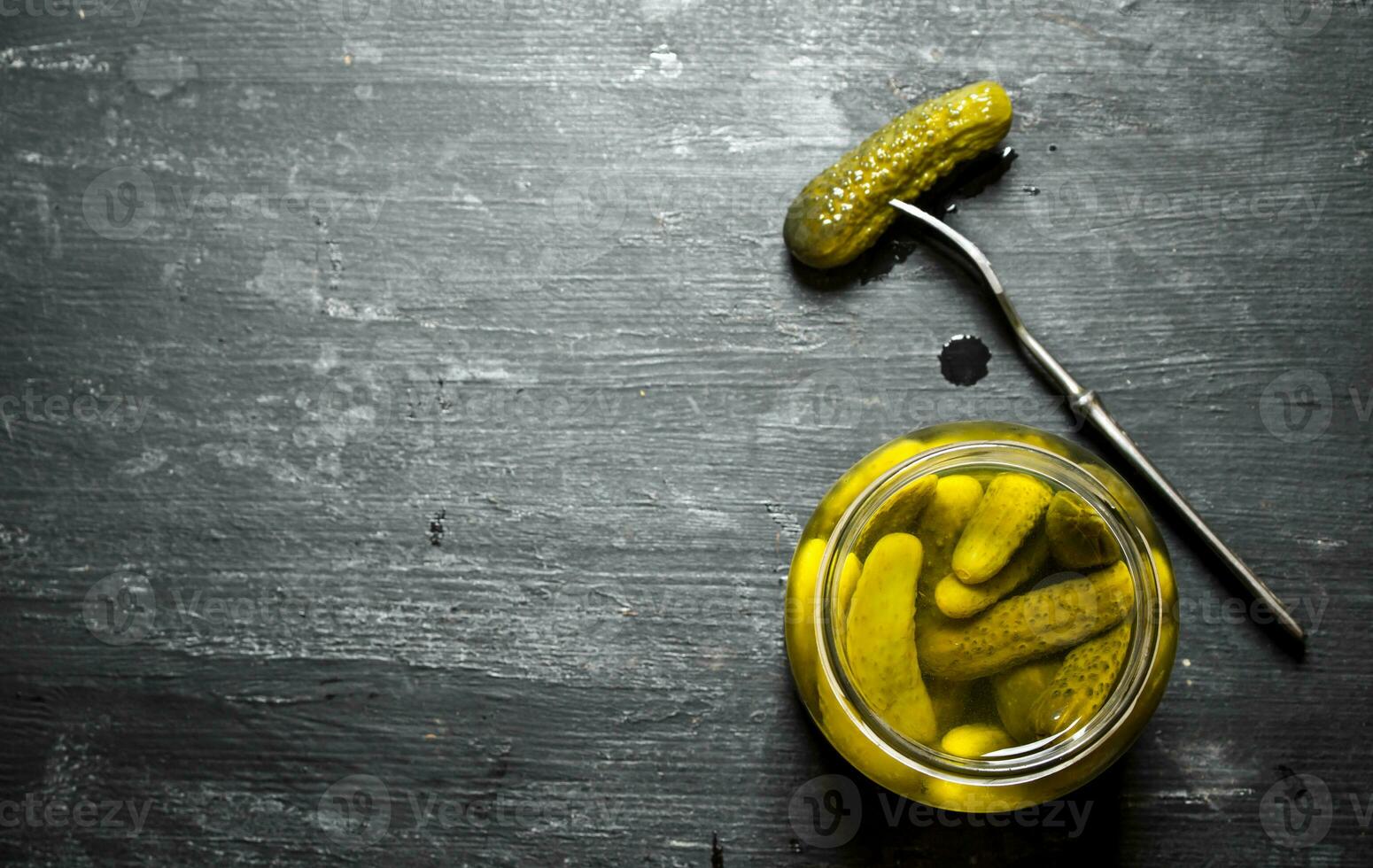 Pickled gherkins in a jar. photo