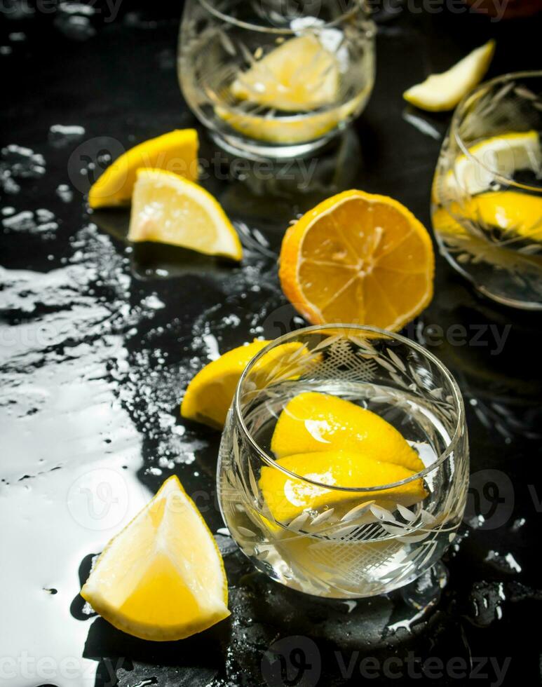 Glasses with vodka and lemon. photo
