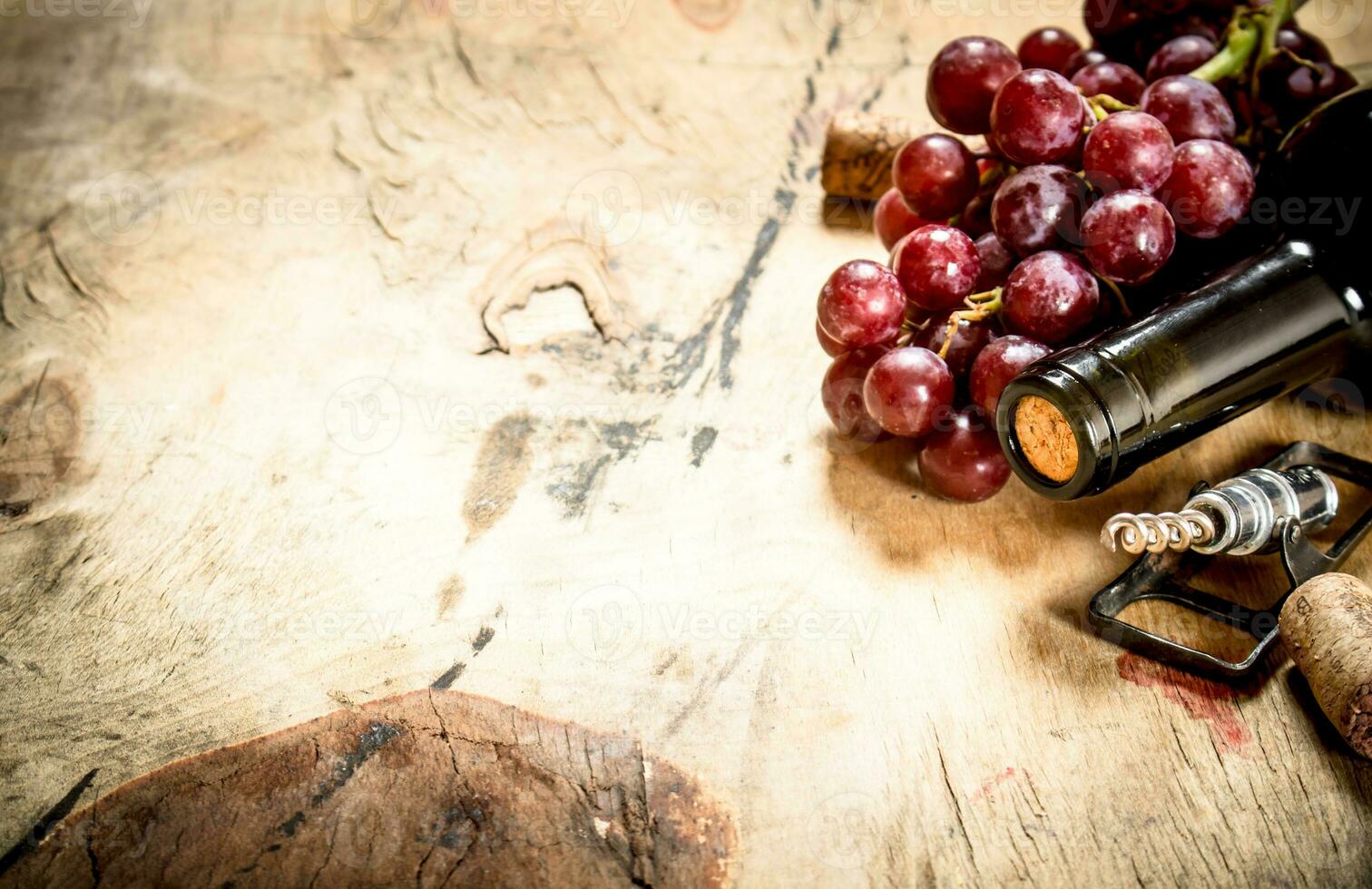 Bottle of red wine with grapes photo